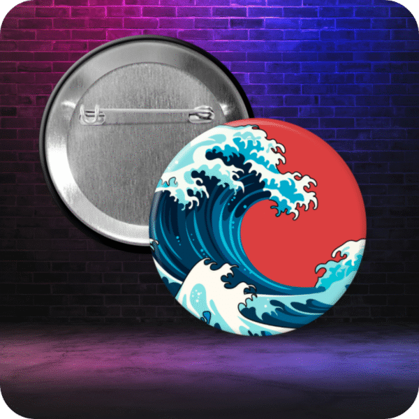 Pinback button featuring stylized image of the famous Japanese tsunami wave against a bright red background. Button is displayed with metal backing on a gradient graffiti-style background.